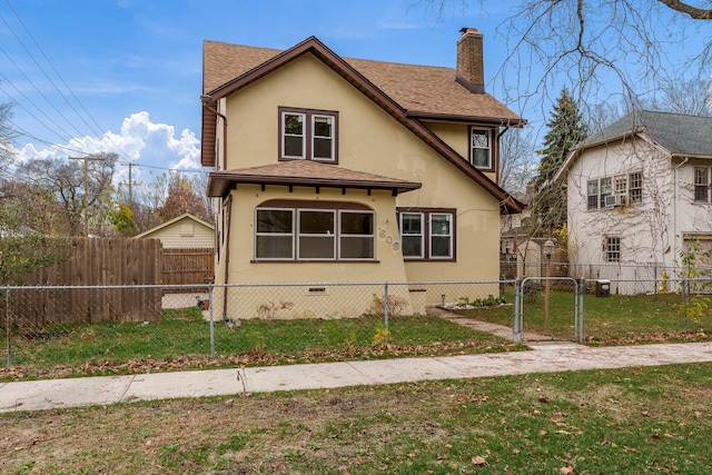 rear view of house featuring a yard