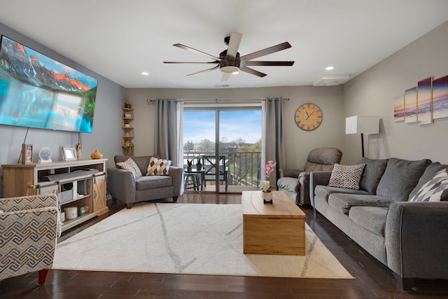 living room with ceiling fan and dark hardwood / wood-style floors