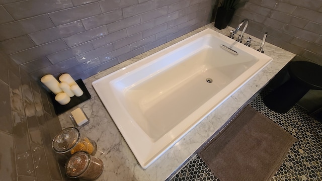 bathroom featuring tiled bath and tile walls