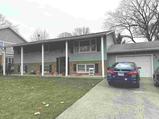 bi-level home with a front yard and a garage