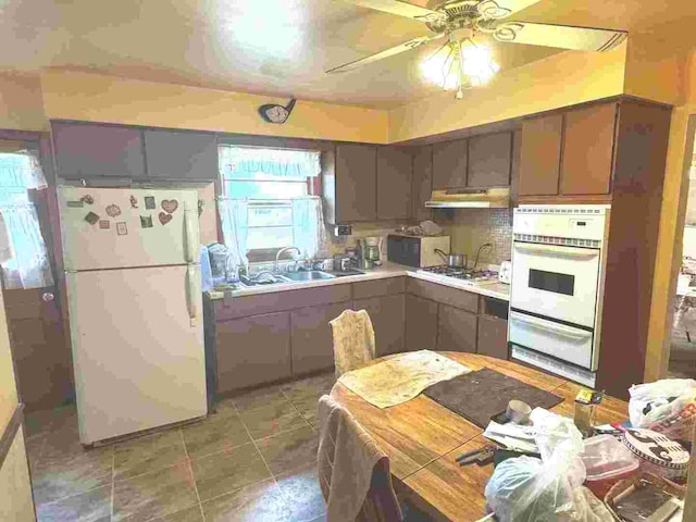 kitchen with white appliances, ceiling fan, and sink