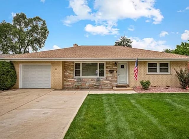 single story home with a front yard and a garage