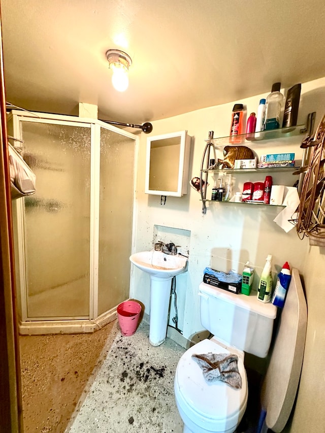 bathroom with sink, an enclosed shower, and toilet