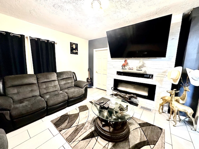 living room with light tile patterned flooring and a textured ceiling