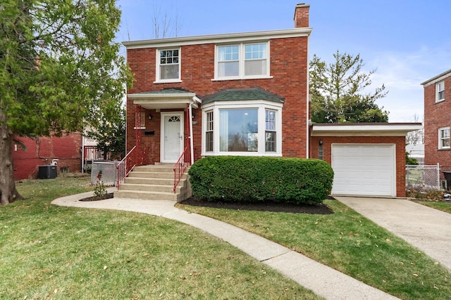 view of front of house with central AC, a front yard, and a garage