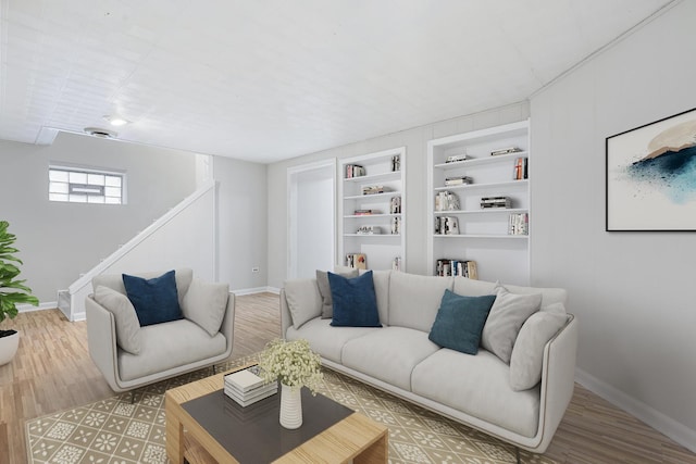 living room featuring hardwood / wood-style floors and built in features