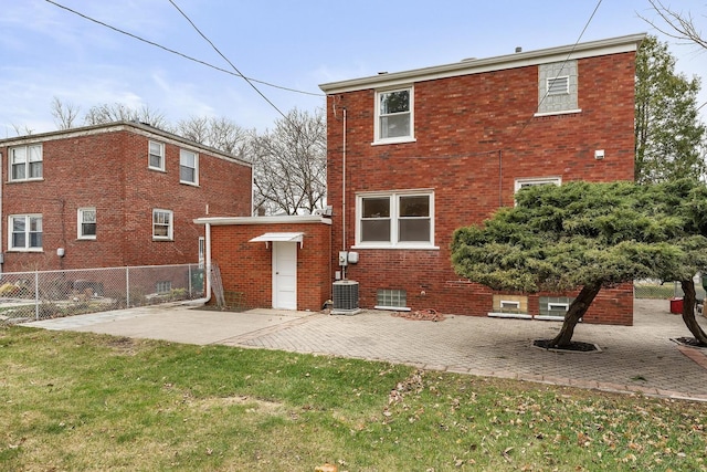 rear view of house with a lawn, a patio, and central AC