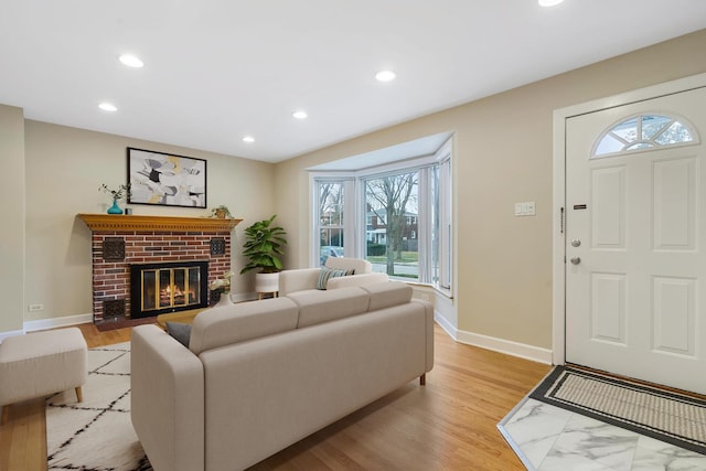 living room with a fireplace and light wood-type flooring