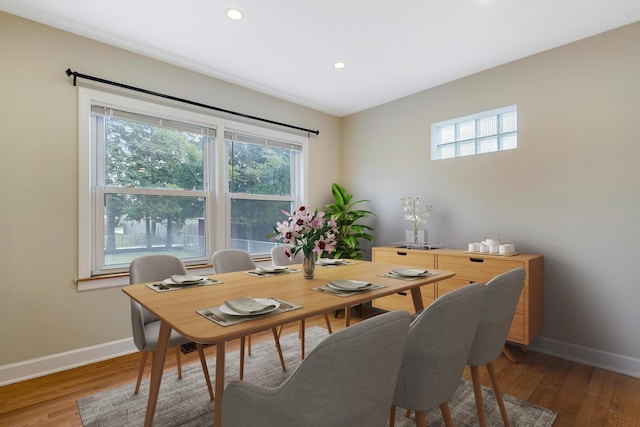 dining space with hardwood / wood-style flooring