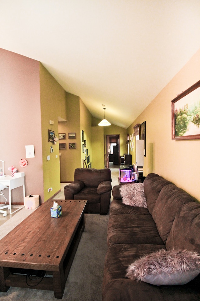 carpeted living room with lofted ceiling