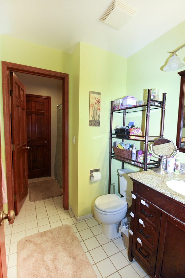 bathroom with toilet, vanity, tile patterned floors, and curtained shower