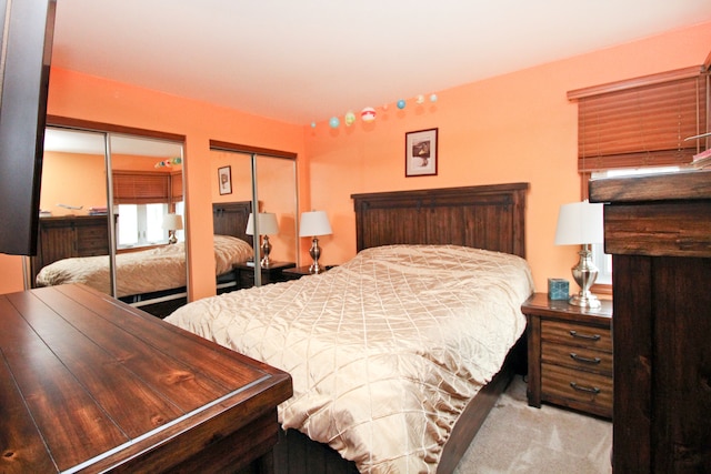 carpeted bedroom with two closets