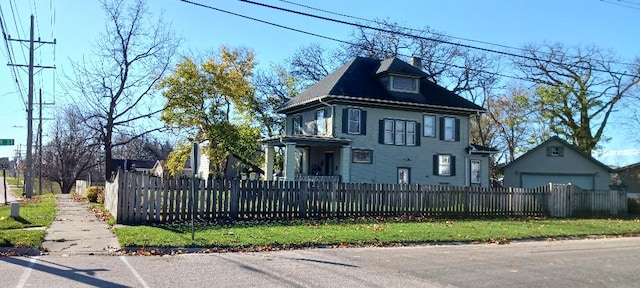 view of front facade featuring a garage and an outbuilding