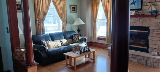 living room with a fireplace and wood-type flooring