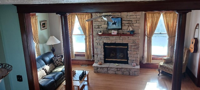 living room with a fireplace and wood-type flooring