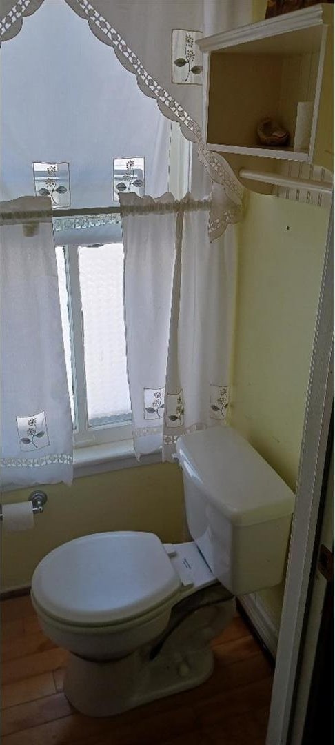 bathroom with toilet and hardwood / wood-style flooring