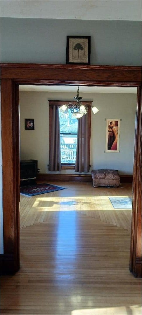 interior space featuring an inviting chandelier and wood-type flooring