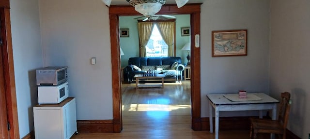 corridor with hardwood / wood-style flooring