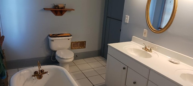 bathroom featuring toilet, vanity, tile patterned flooring, and a bathtub