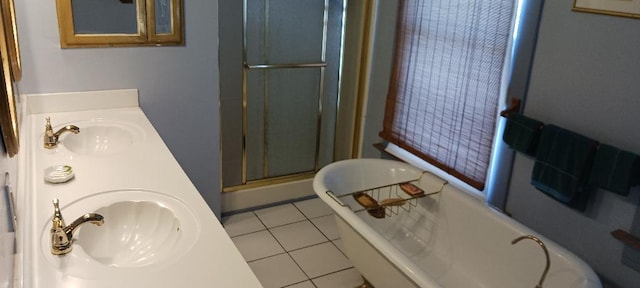 bathroom with tile patterned flooring, vanity, and walk in shower