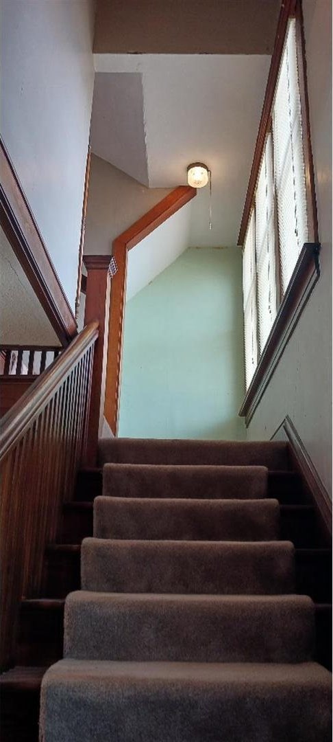 stairs featuring lofted ceiling