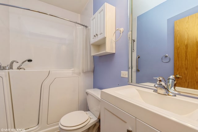 bathroom with vanity, toilet, and walk in shower