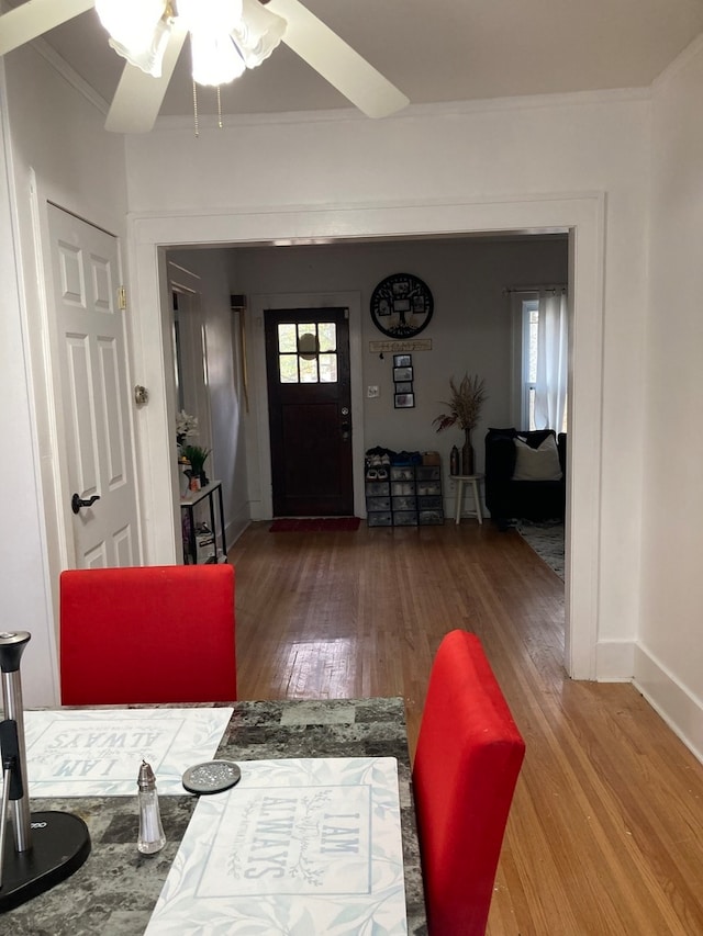 foyer featuring hardwood / wood-style flooring, ceiling fan, and ornamental molding