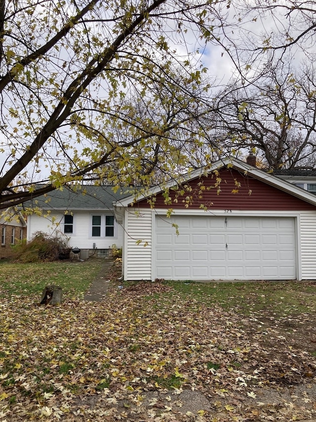 view of side of home with a garage and an outdoor structure