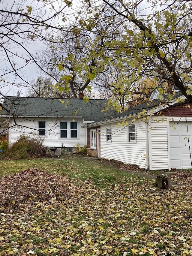 back of house with a garage