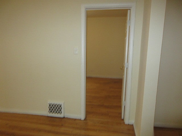 corridor with wood-type flooring