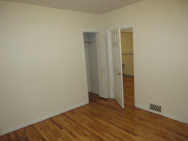 unfurnished bedroom featuring hardwood / wood-style flooring