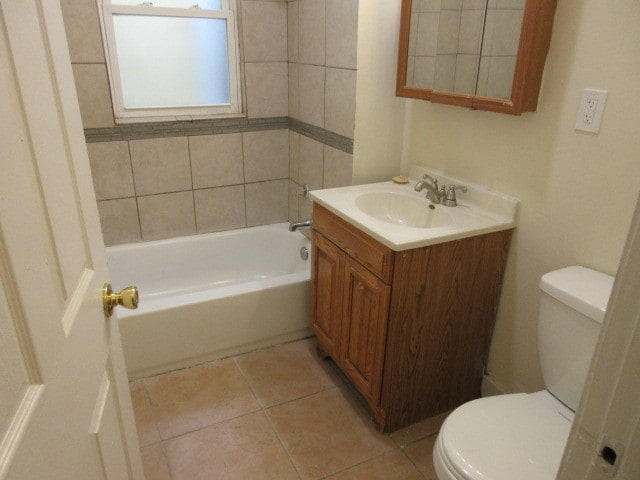 bathroom featuring toilet, vanity, and tile patterned floors