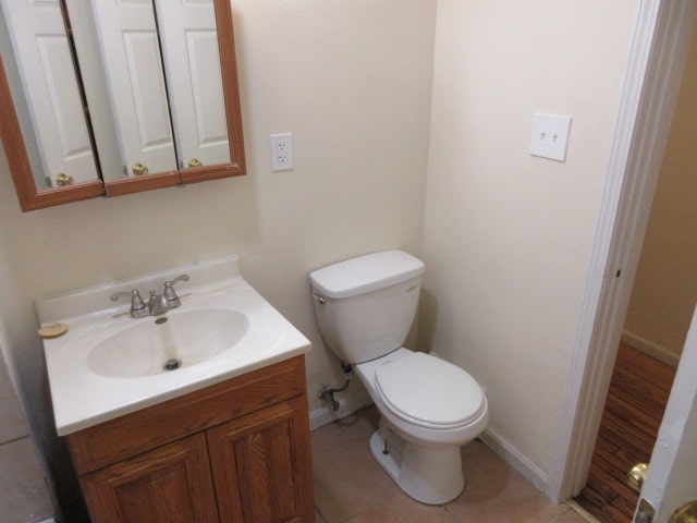 bathroom with tile patterned floors, vanity, and toilet