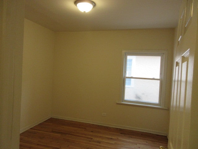 spare room with hardwood / wood-style flooring