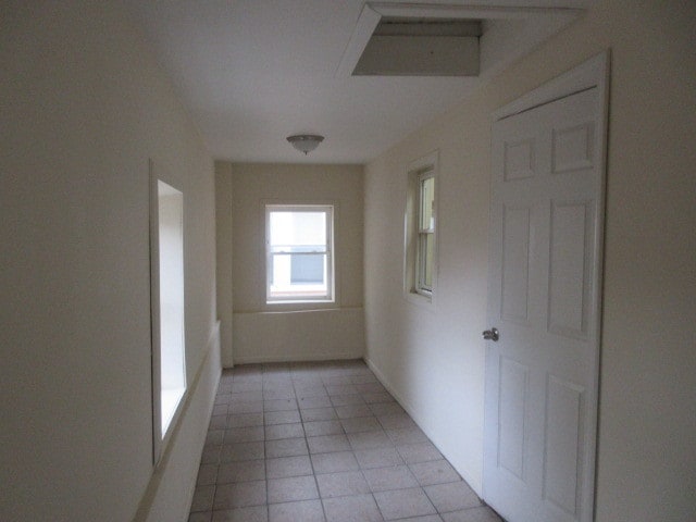 hallway with light tile patterned floors