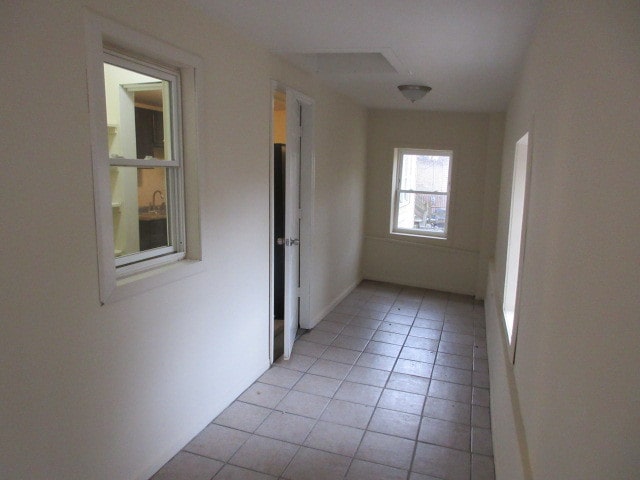 corridor with light tile patterned flooring