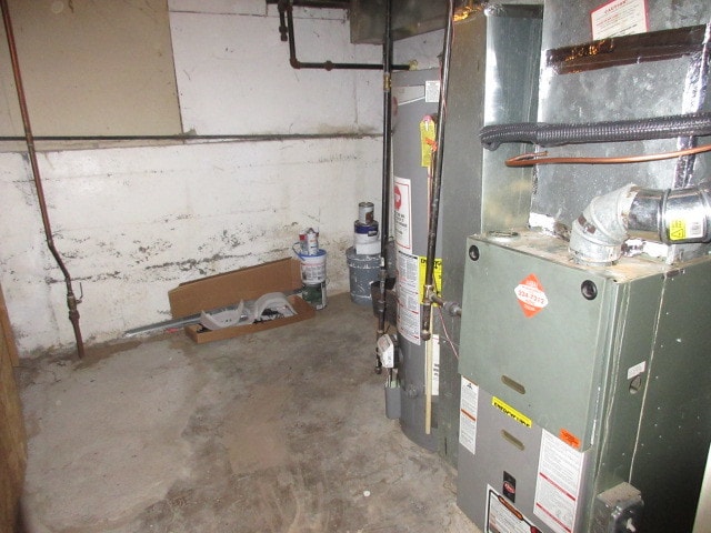 utility room featuring heating unit