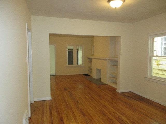 empty room with hardwood / wood-style flooring