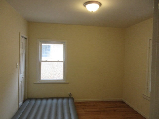 unfurnished room featuring dark hardwood / wood-style flooring