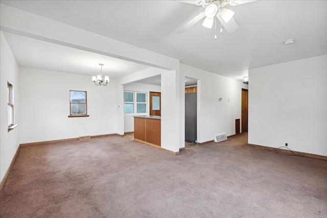 unfurnished living room with light carpet and ceiling fan with notable chandelier