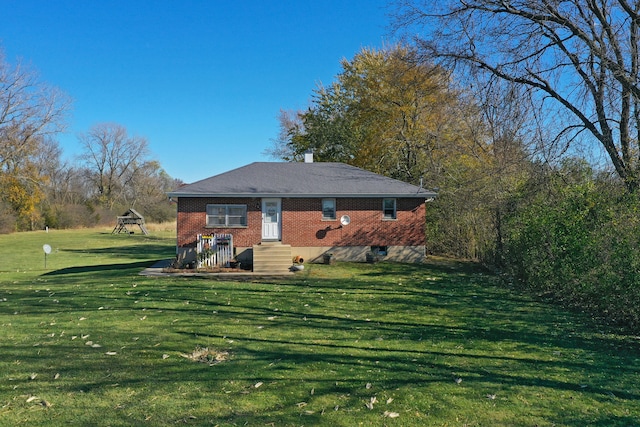 back of house with a lawn