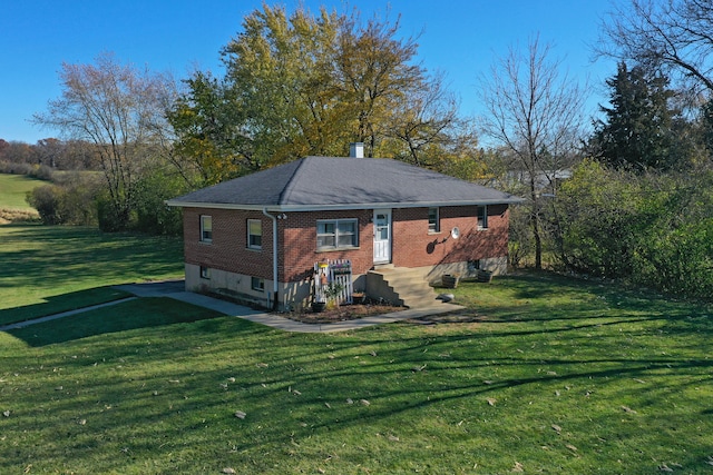 back of property featuring a yard