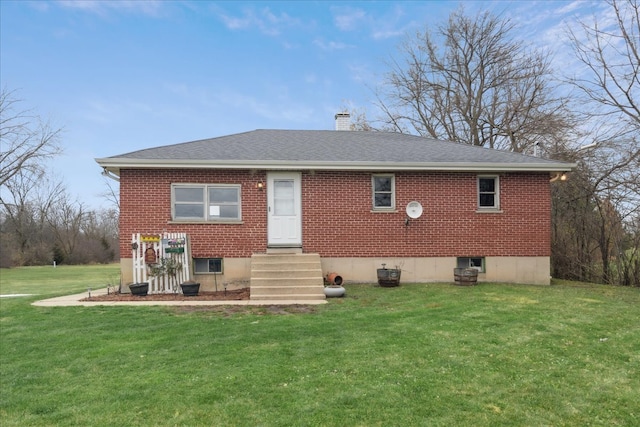 rear view of house with a lawn