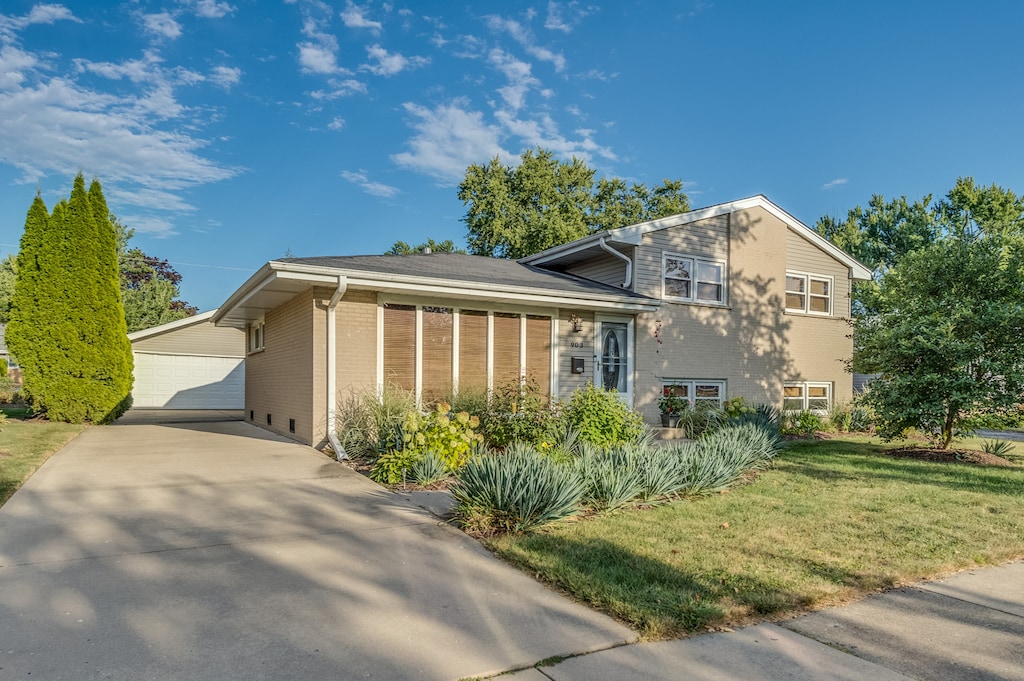 view of home's exterior with a yard and a garage