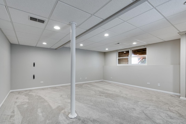 basement with carpet flooring and a drop ceiling