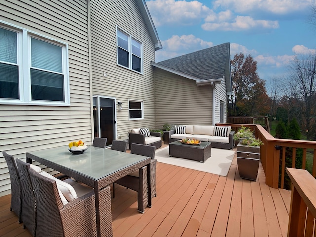 wooden terrace with an outdoor living space