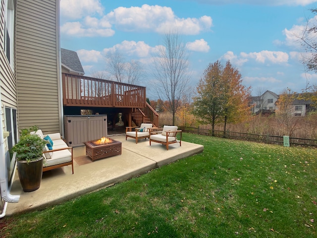 view of yard with a patio, a deck, and an outdoor living space with a fire pit