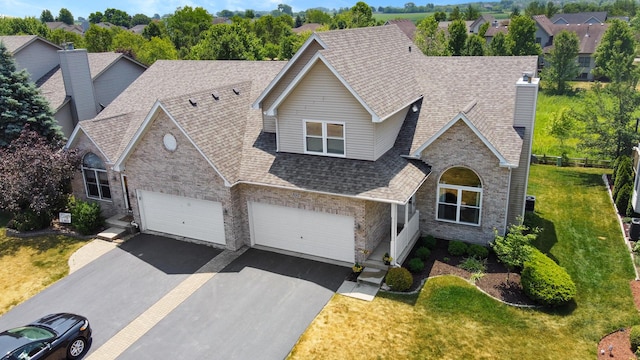 view of front of house with a garage and a front yard