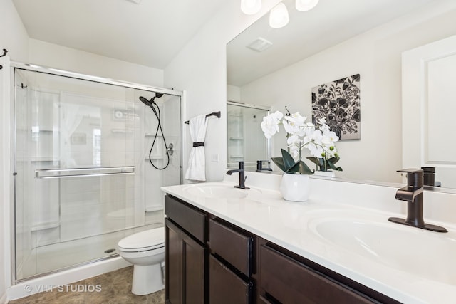 bathroom featuring walk in shower, vanity, and toilet