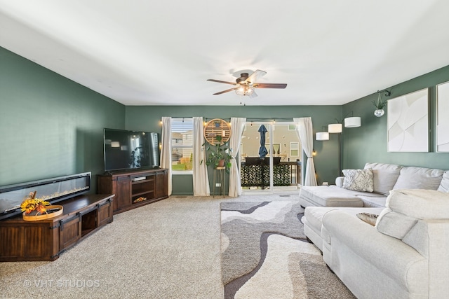 living room featuring carpet flooring and ceiling fan